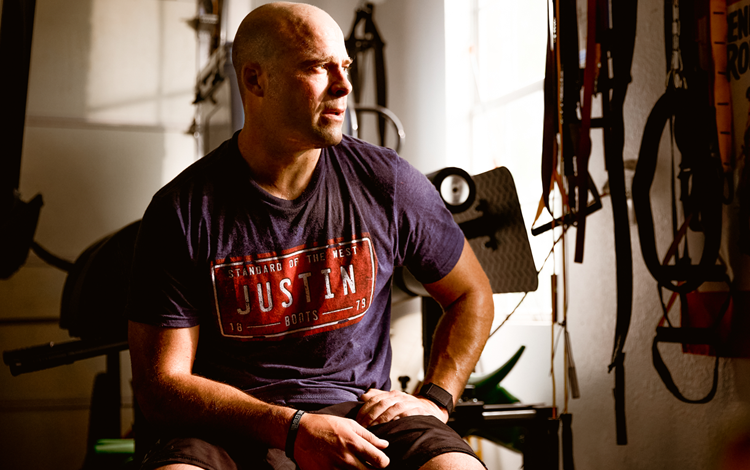 Dusty sitting on gym equipment 